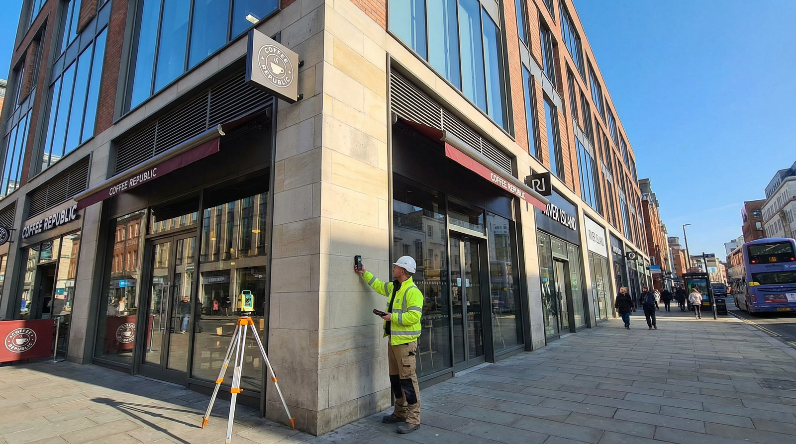 Commercial property building with surveyor taking measurements